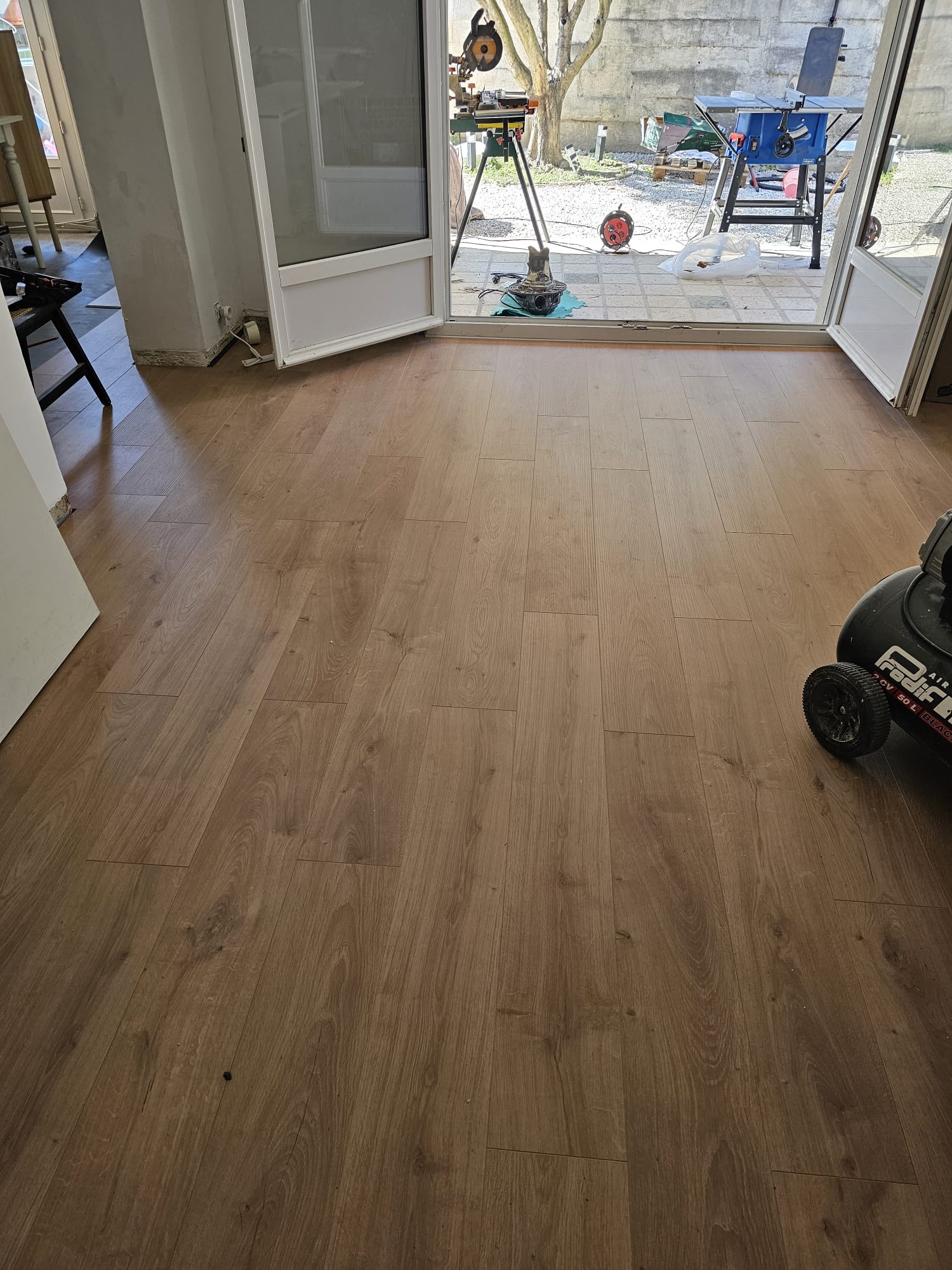 Parquet flottant à lames droites terminé, vue depuis baie vitrée